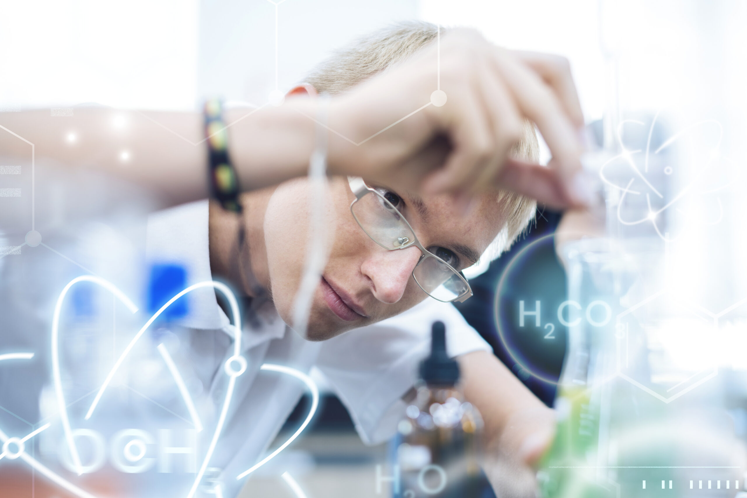 Student doing chemistry and physics experiment high school science program