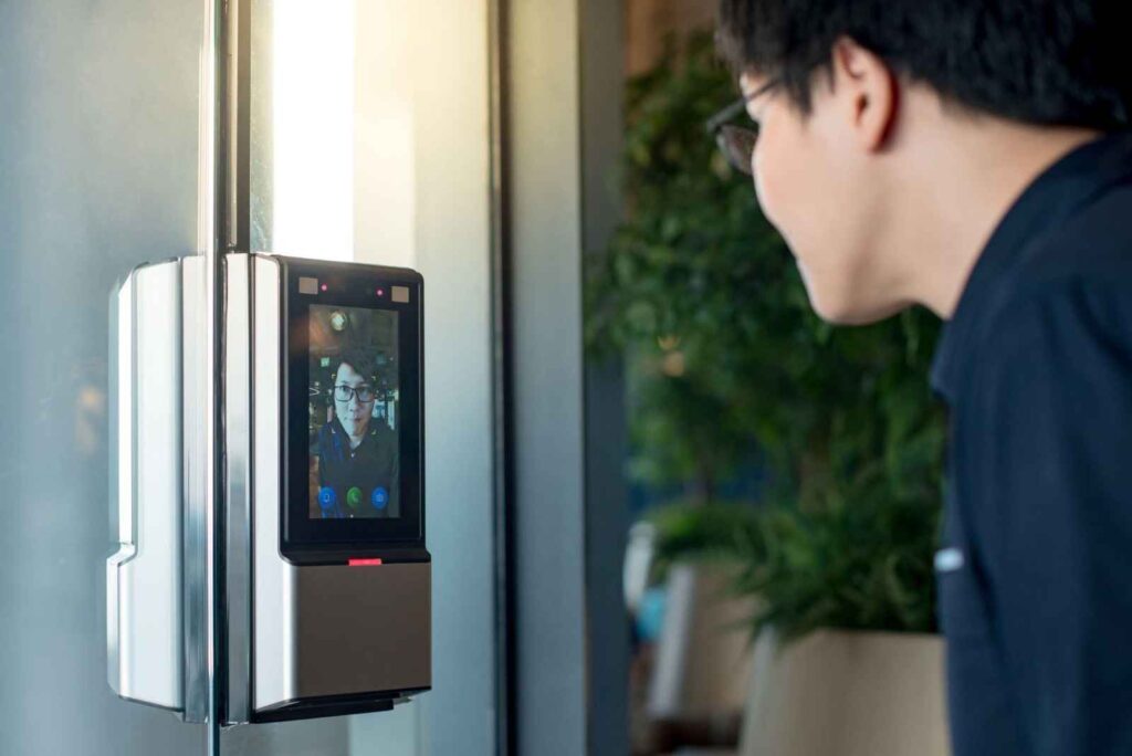 Man is entering his house through access control system