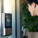 Man is entering his house through access control system