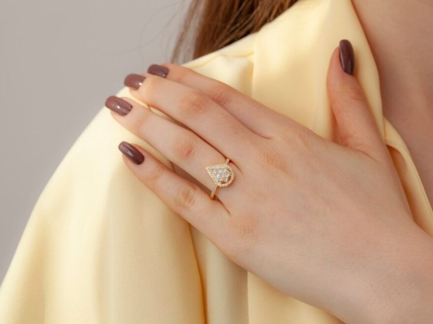 woman in yellow blouse shows elegant ring