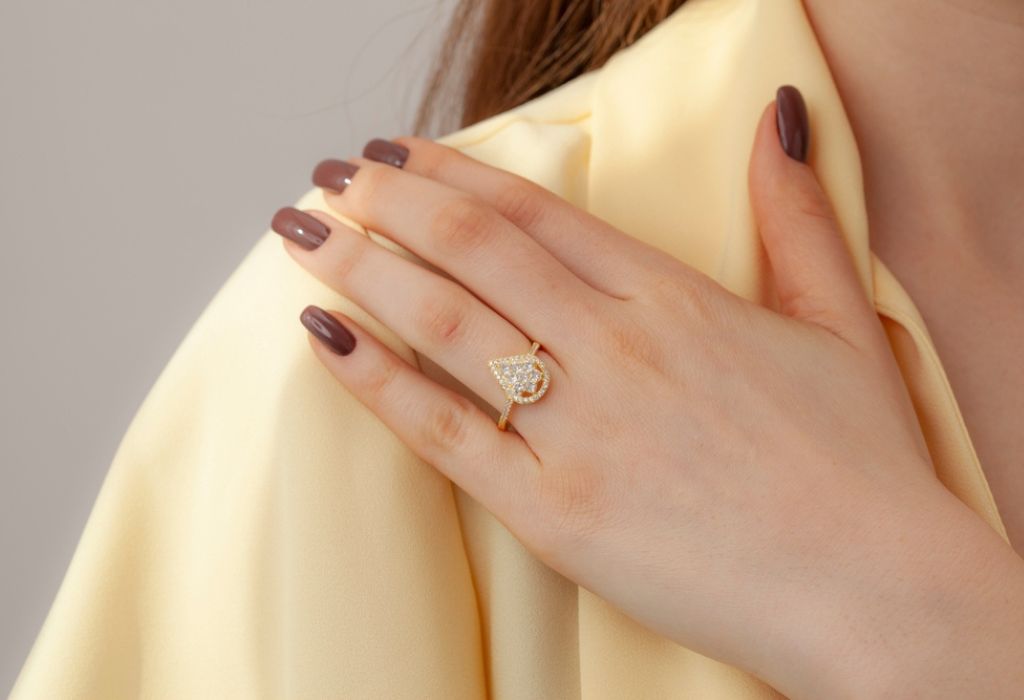 woman in yellow blouse shows elegant ring