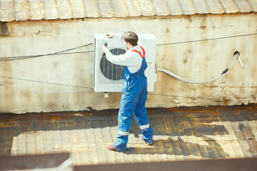 HVAC professional working on a air source heat pumps maintenance.