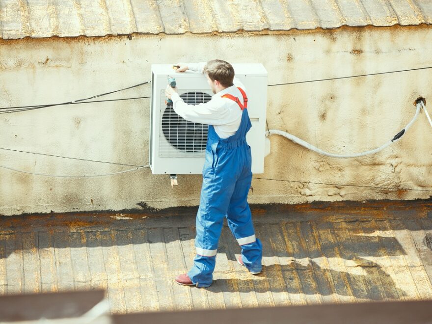 HVAC professional working on a air source heat pumps maintenance.