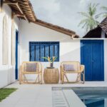 a chair and table next to a pool