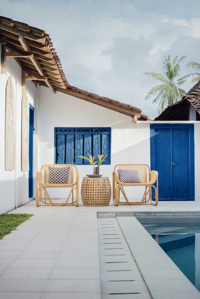 a chair and table next to a pool