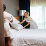 hotel maids making the bed together