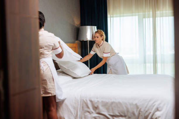 hotel maids making the bed together