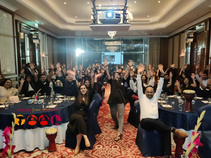 Employees raising hands together in a team building session