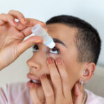 Man applying saline solution for eye wash