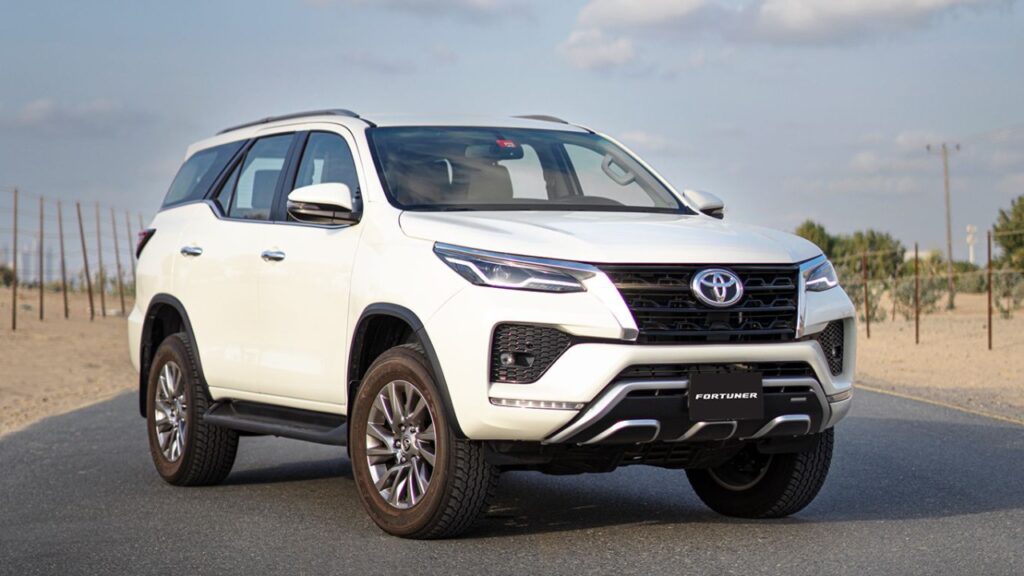 A Toyota Fortuner driving on a road, showcasing its sleek design and powerful performance.