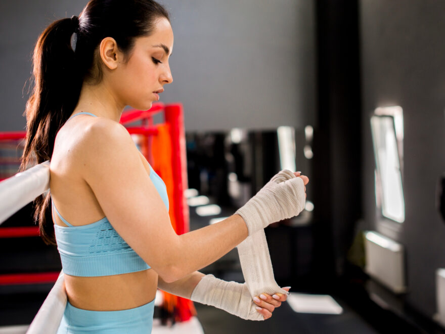 A sports girl using pre wrap athletic tape