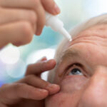 A man applying saline solution for eyes on his eyes