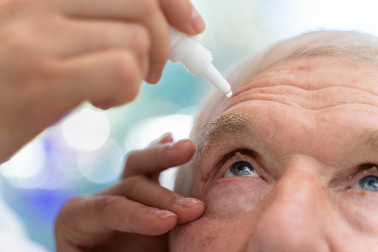 A man applying saline solution for eyes on his eyes