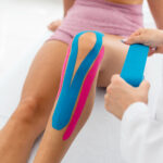 applying kt athletic tape on knee