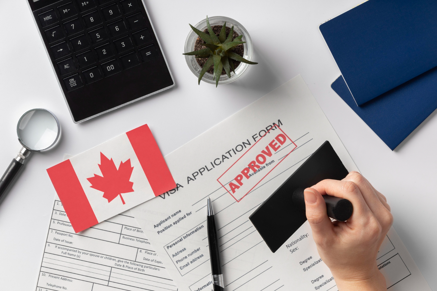 Close-up of a Canadian visa stamp in a passport alongside a Canadian flag, representing successful visa assistance by Canadian visa consultants in Hyderabad.