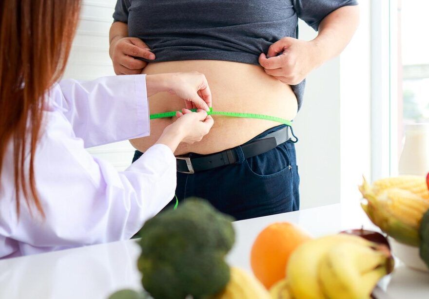 female-doctor-nutritionist-checks-health-obese-person-using-tape-measure-around-waist-obese-man-weight-loss-concept-medical-services-hospitals