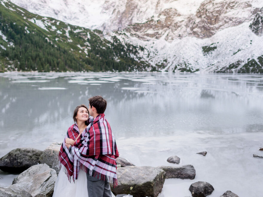 Couple standing in front of a famous Canadian landmark, symbolizing the experience of traveling to Canada with a spouse visitor visa Canada.