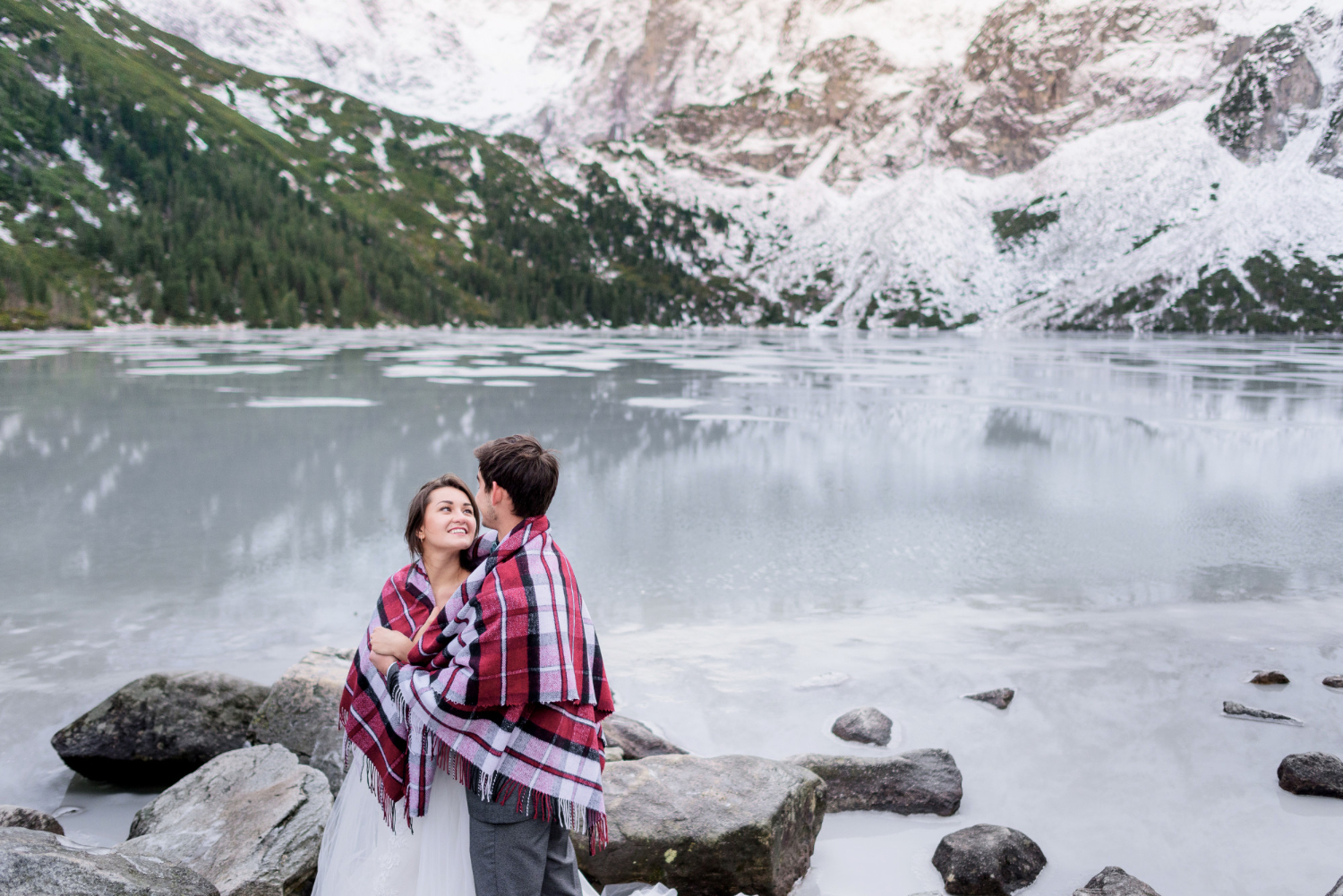 Couple standing in front of a famous Canadian landmark, symbolizing the experience of traveling to Canada with a spouse visitor visa Canada.