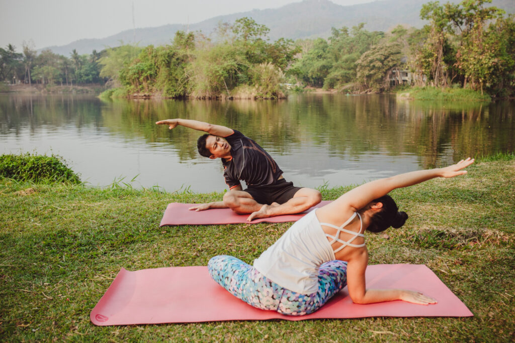 Yoga partners stretching their bodies at a peaceful yoga retreat center Bali