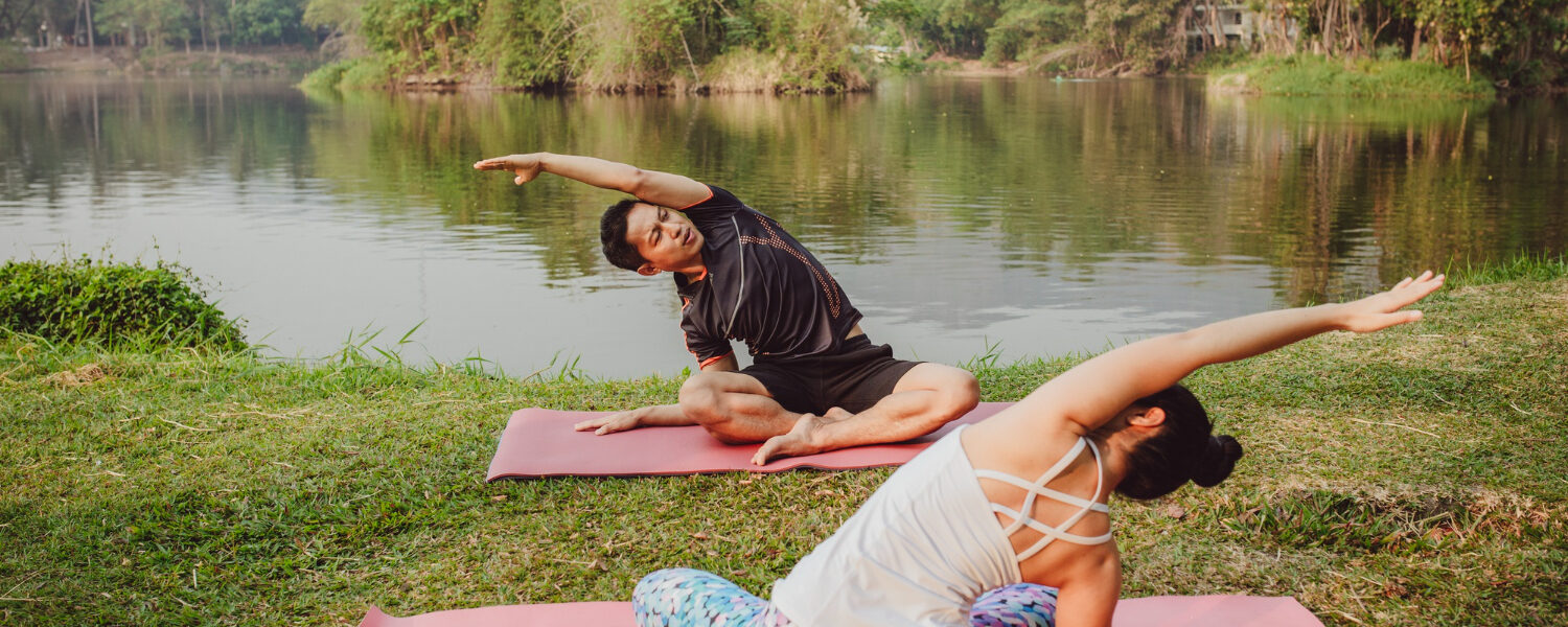 Yoga partners stretching their bodies at a peaceful yoga retreat center Bali