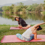 Yoga partners stretching their bodies at a peaceful yoga retreat center Bali